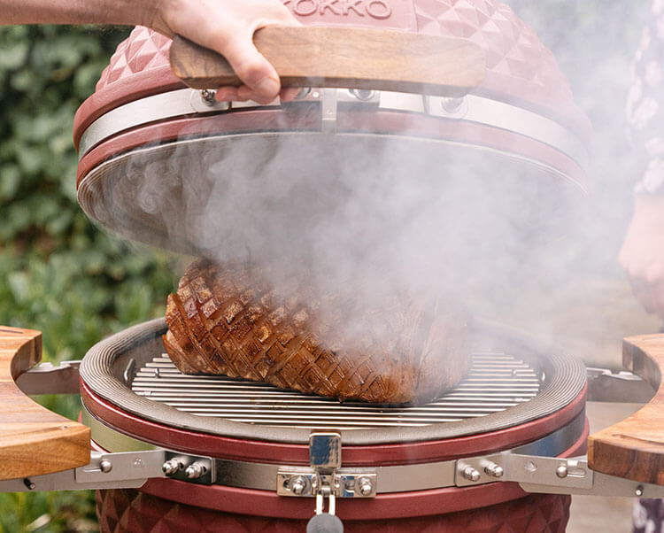 Kamado Kokko gebruikt voor warm roken, toont het garen van voedsel met rookontwikkeling voor een intense smaakbeleving.